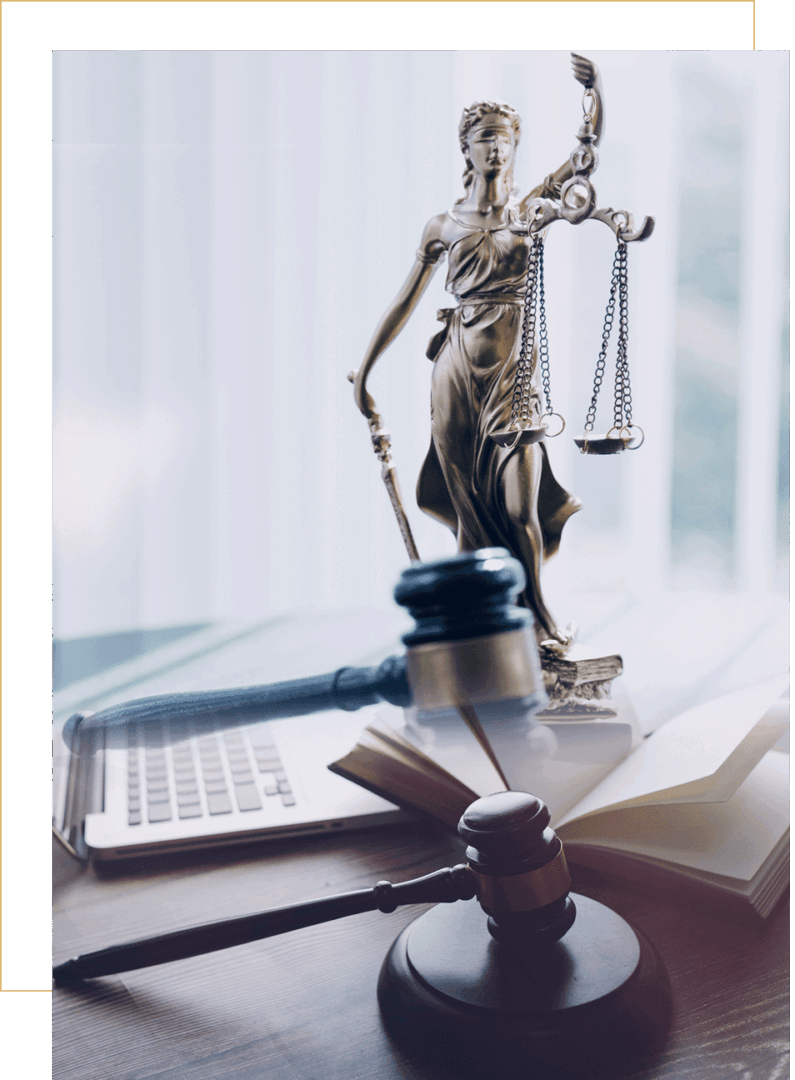 Lady Justice statue with gavel and laptop.