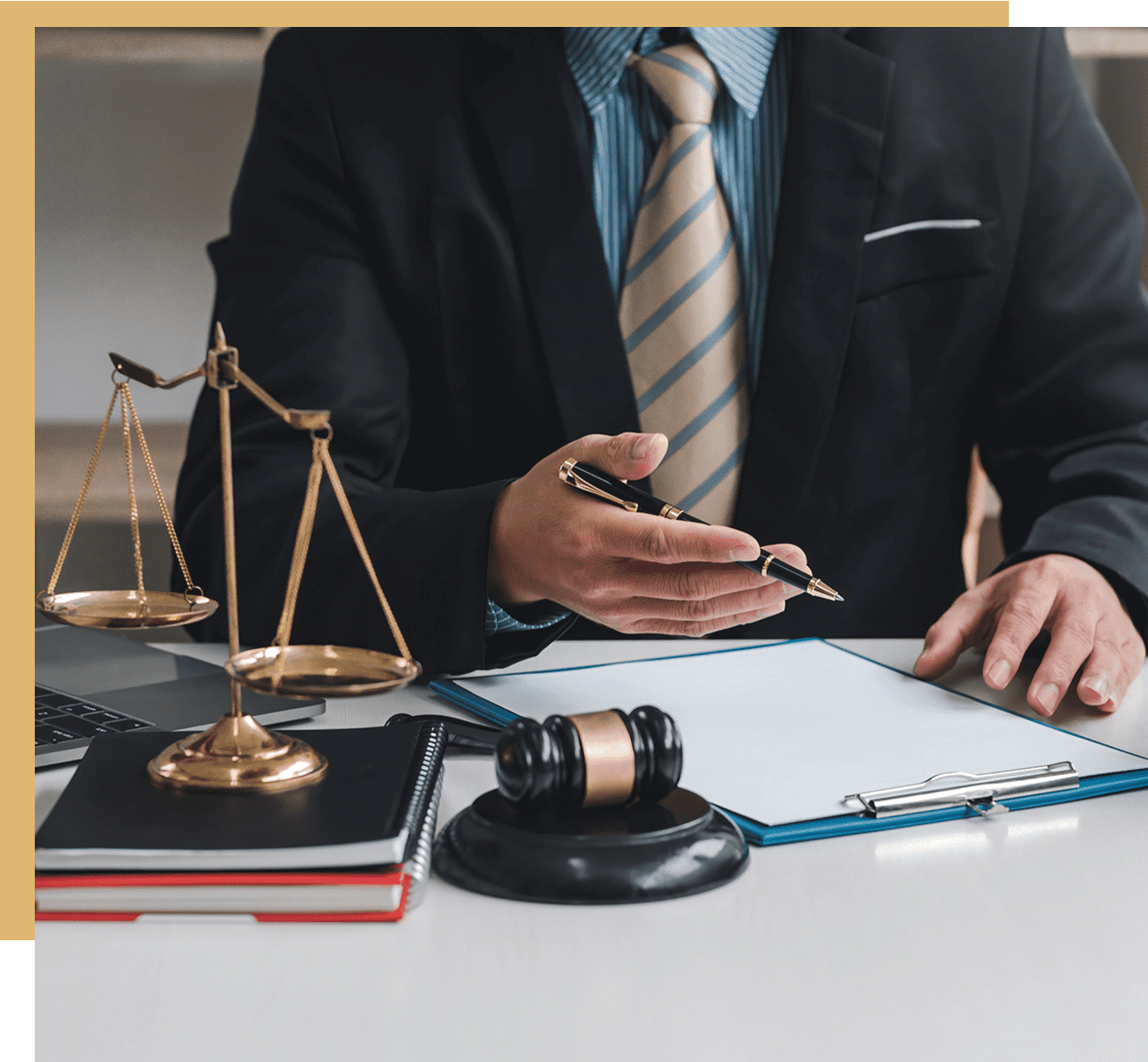 Lawyer at desk with gavel and scales.